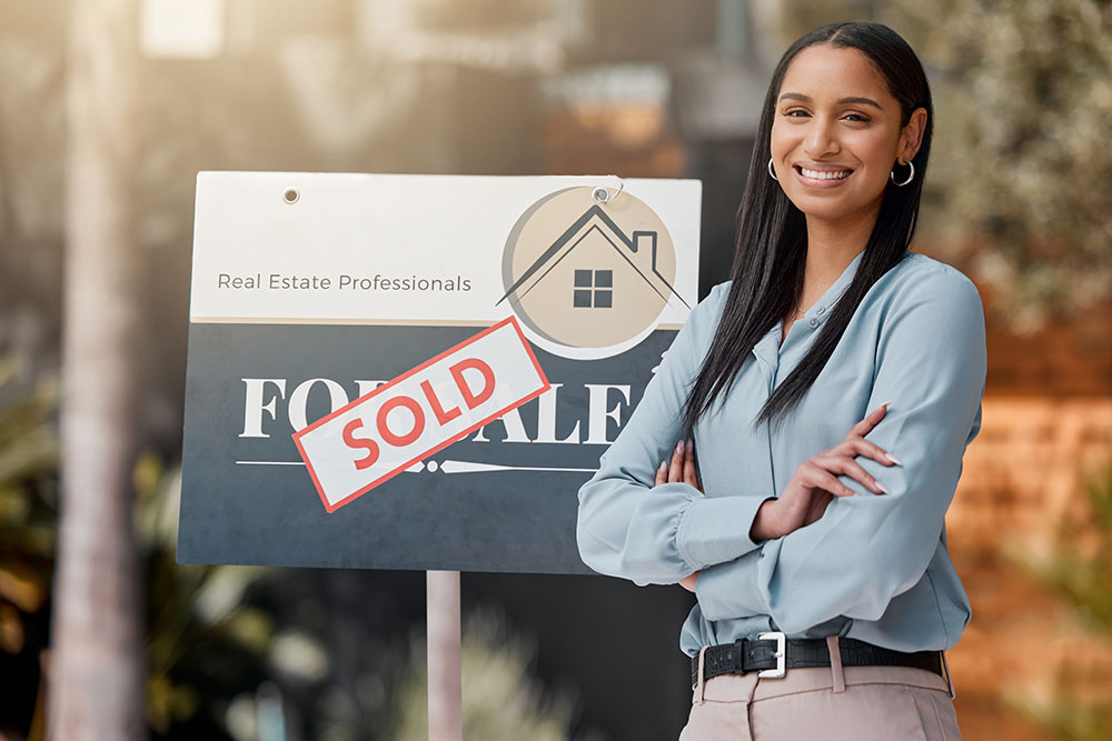 Real estate professional with sold sign